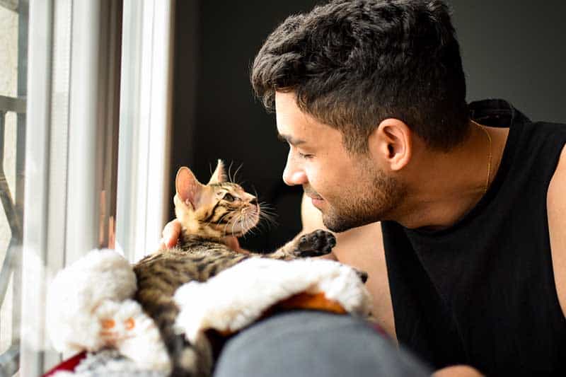 A man with his cat cuddling